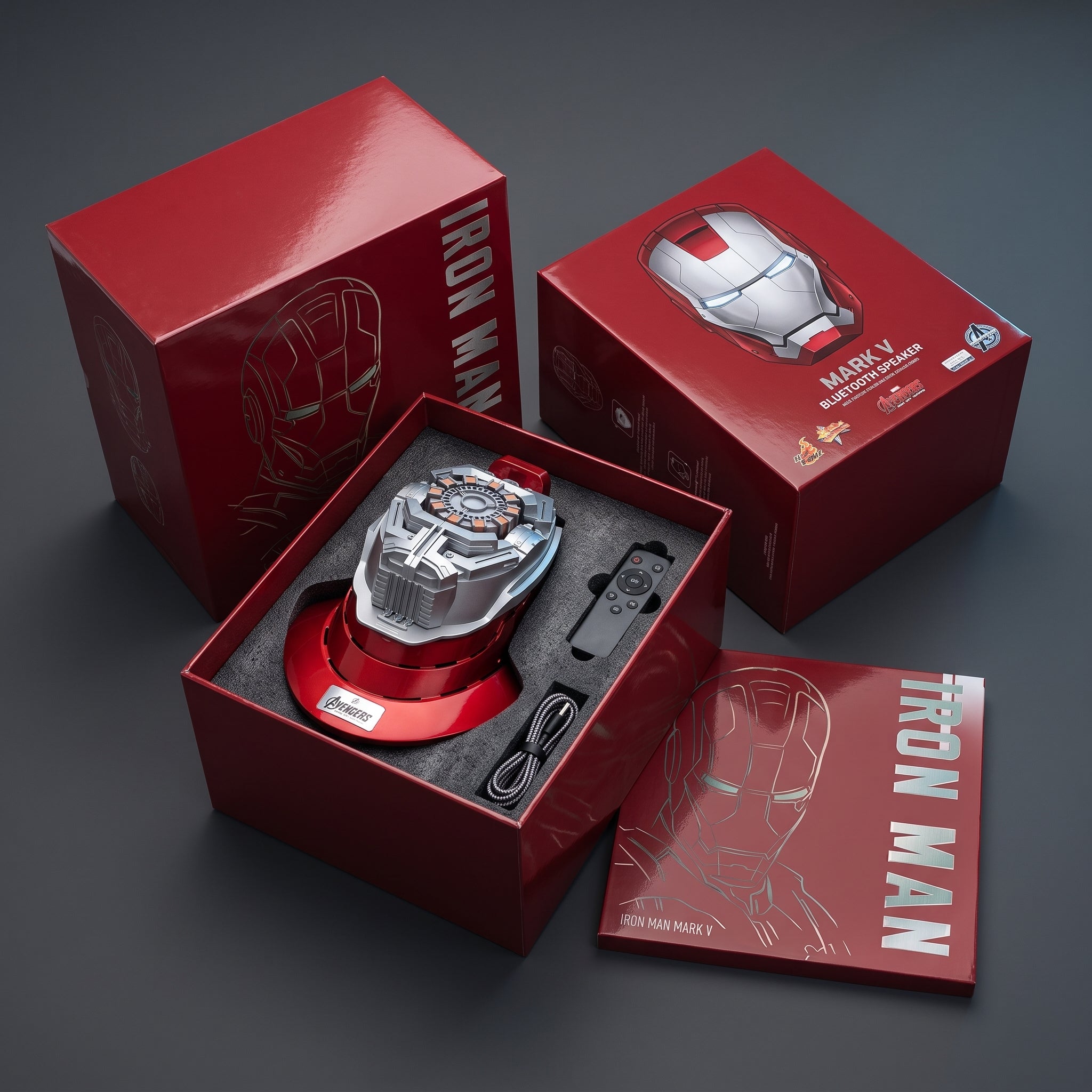 Helmet display stand in its open box with USB charging cable and remote