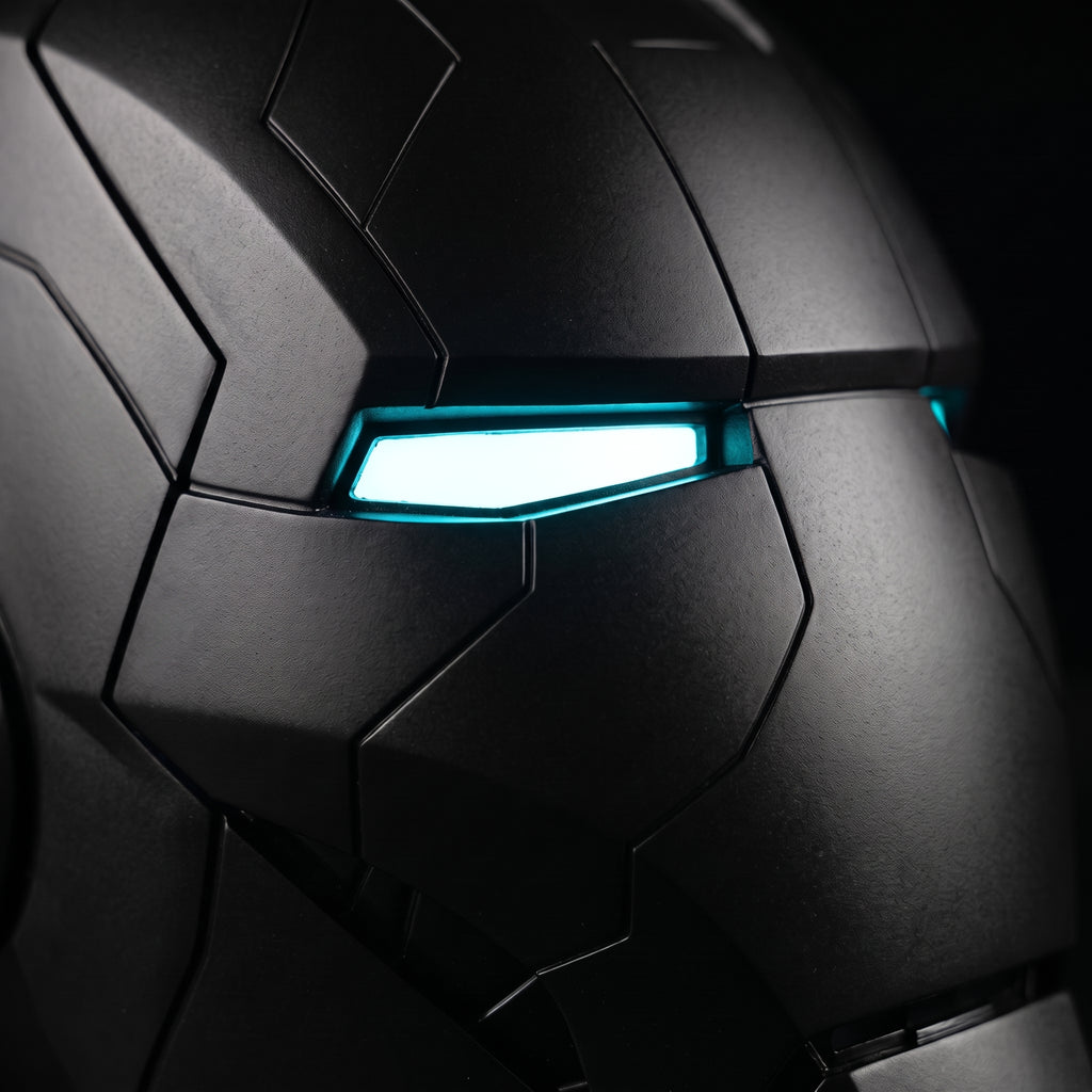 Close-up of the matte black Mark V helmet showing panel seams and illuminated LED eye slits