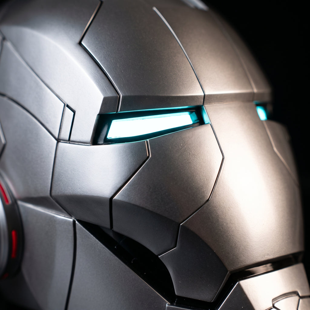 Close-up of the full silver Mark V helmet showing panel seams and illuminated LED eye slits