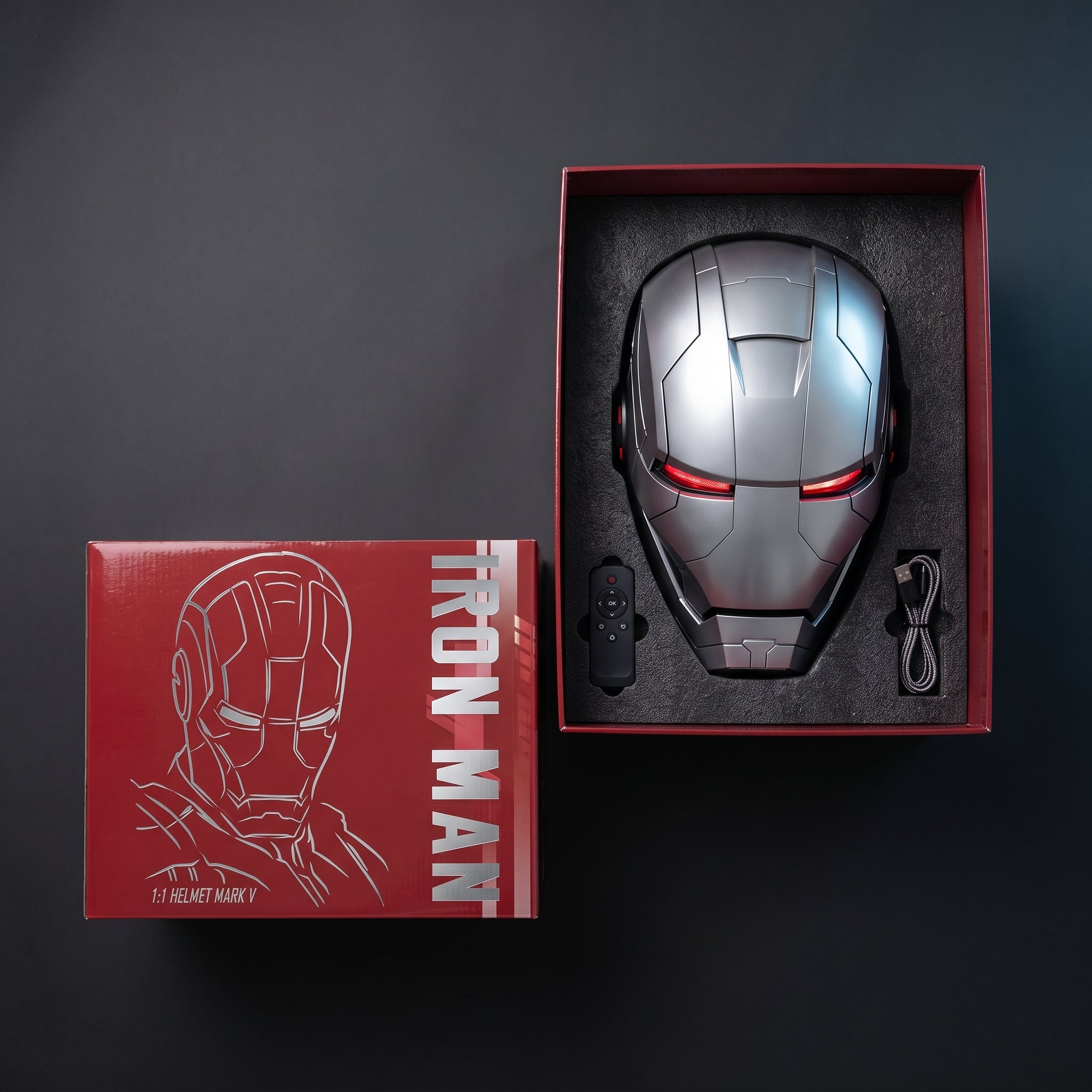Full silver Mark V helmet in its open box with remote control and USB charging cable