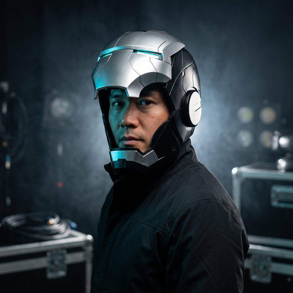 Adult wearing the black and silver Mark V Iron Man helmet with the LED eyes lit