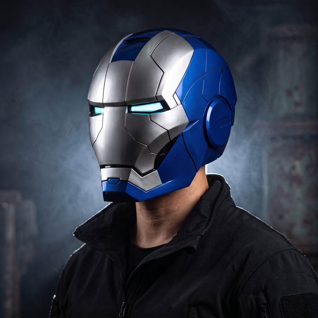 Adult wearing the blue and silver Mark V Iron Man helmet with the LED eyes lit