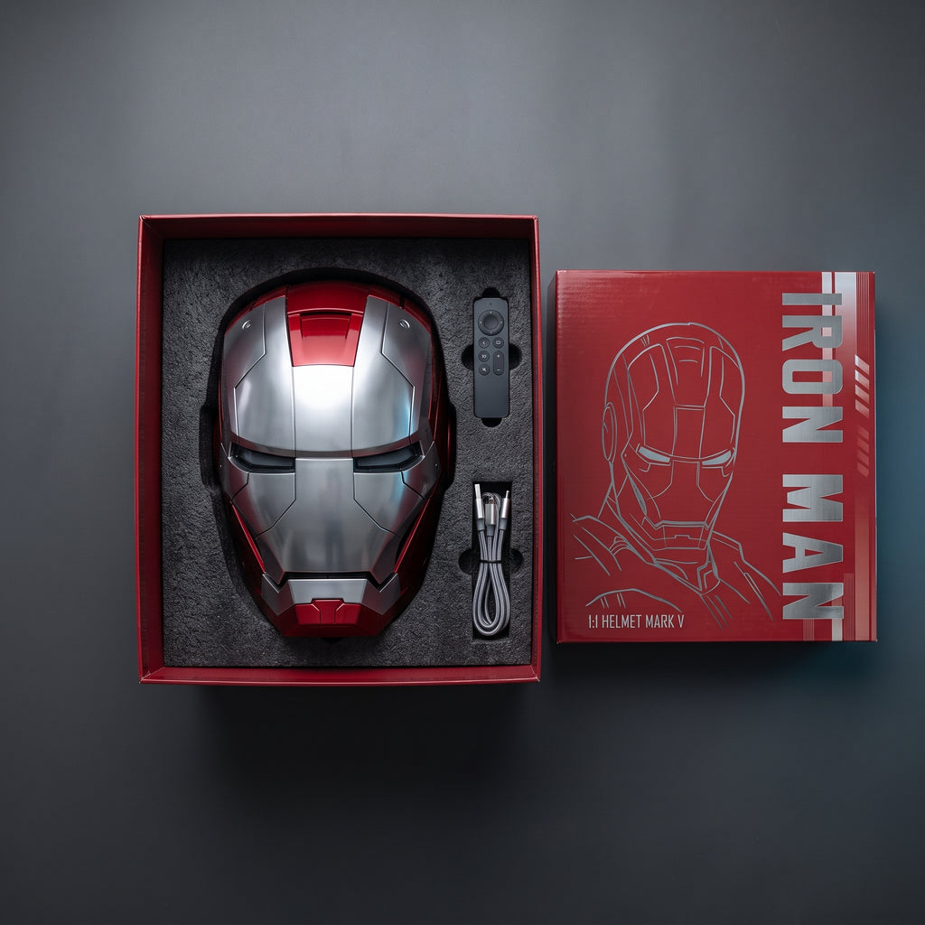 Silver and red Mark V helmet in its open box with remote control and USB charging cable
