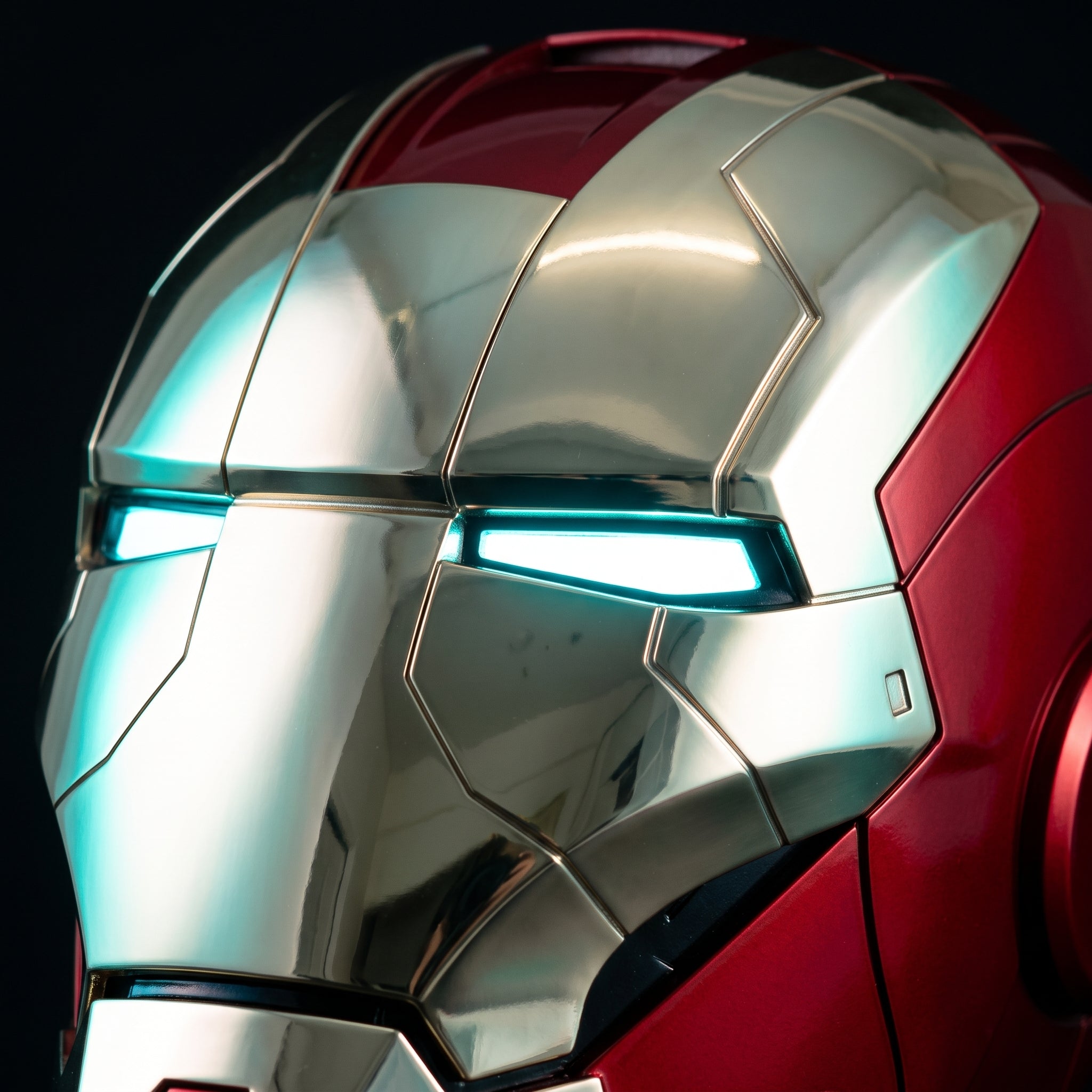 Close-up of the gold and red Mark V helmet showing panel seams and illuminated LED eye slits