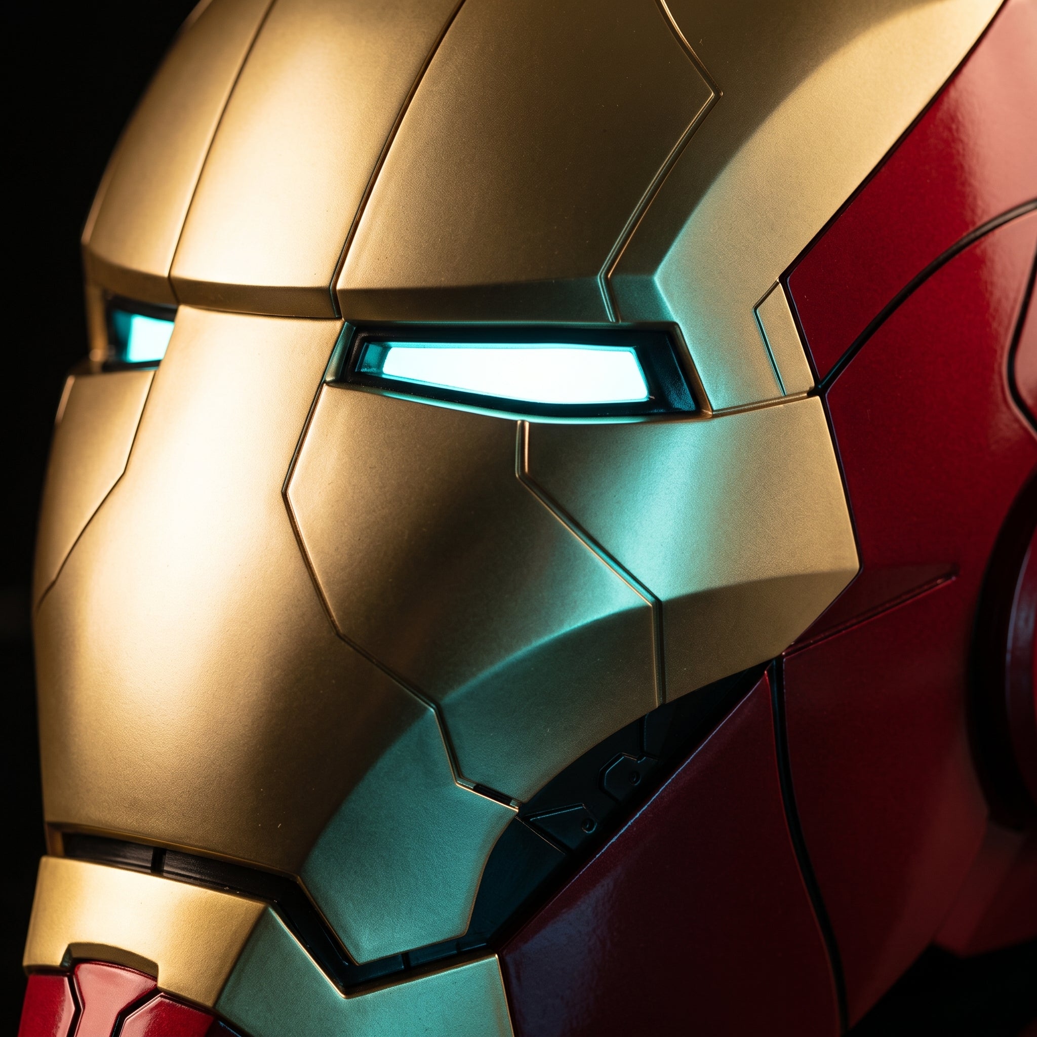 Close-up of the matte gold and red Mark V helmet showing seams and lit LED eye slits