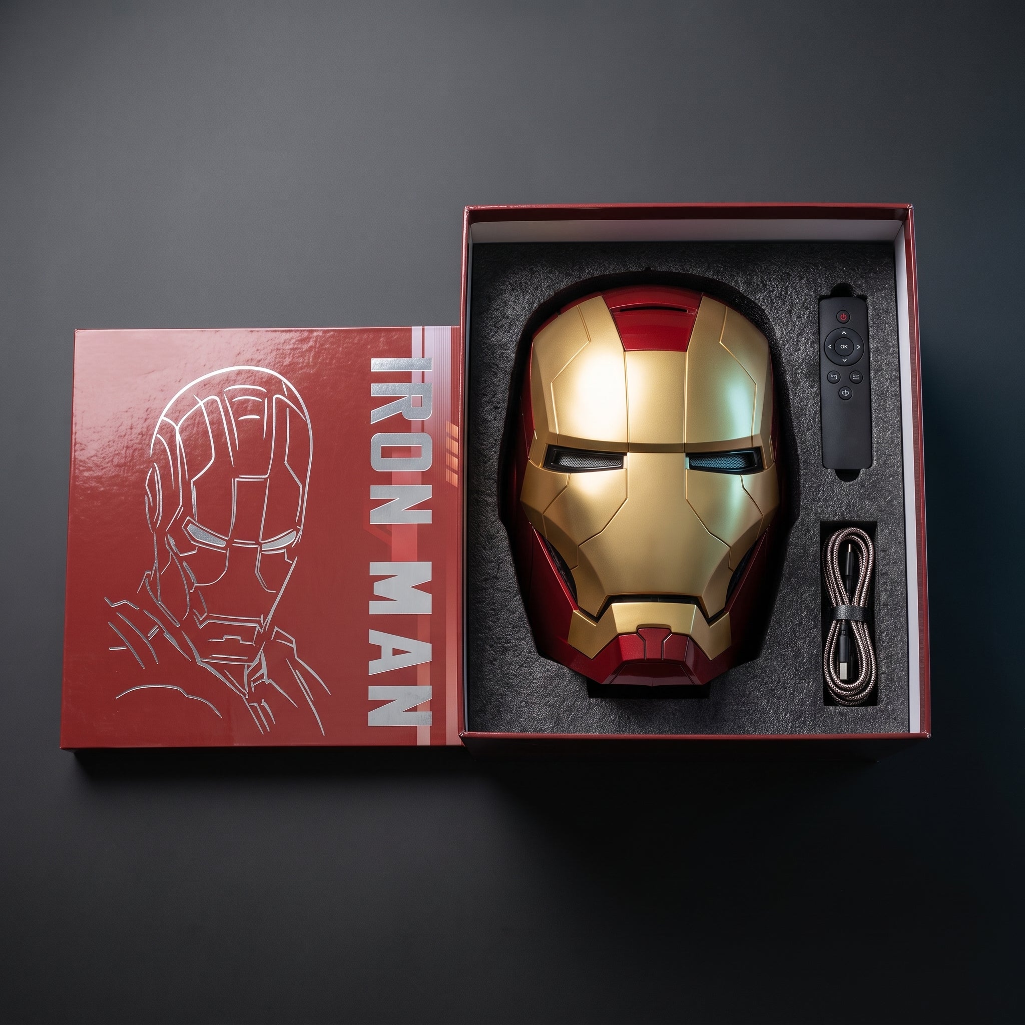 Matte gold and red Mark V helmet in its open box with remote and USB charging cable