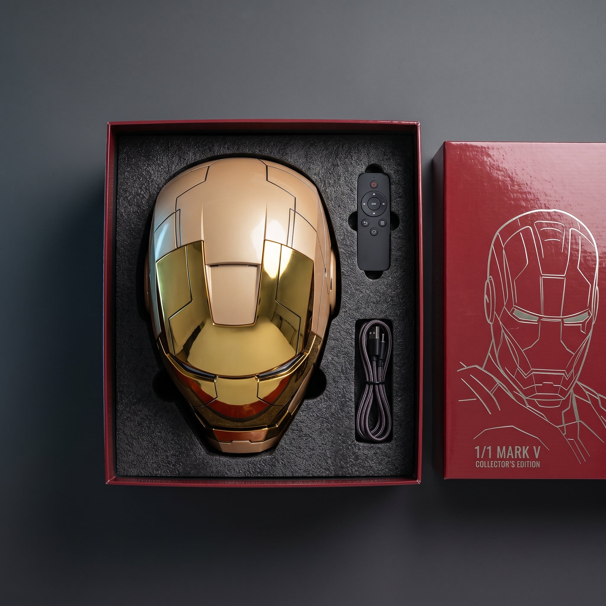 Full mirror gold Mark V helmet in its open box with remote and USB charging cable
